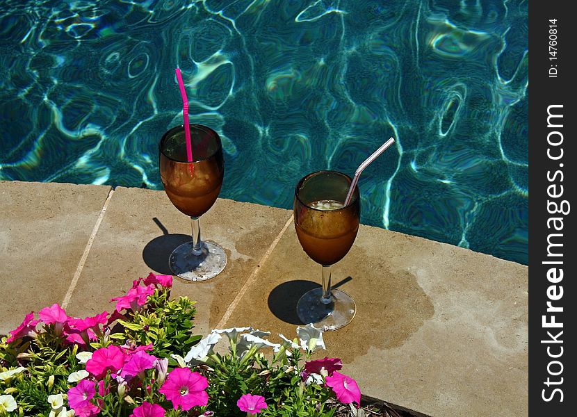 Relaxing drinks by an inviting pool in the summer. Relaxing drinks by an inviting pool in the summer.