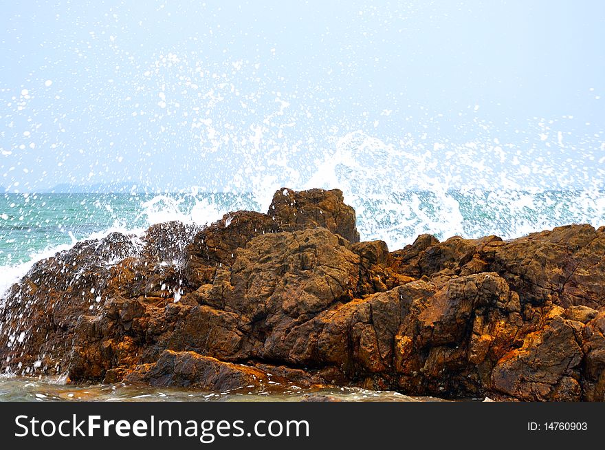 Reef on beach and surge hitting, to become white wave and spray. Reef on beach and surge hitting, to become white wave and spray.