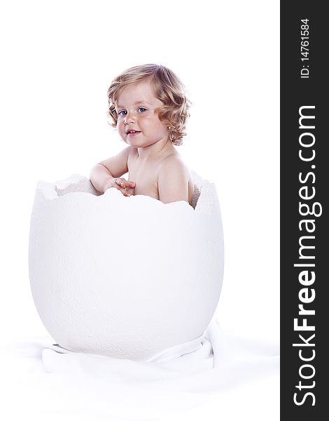 Baby girl in egg on white background