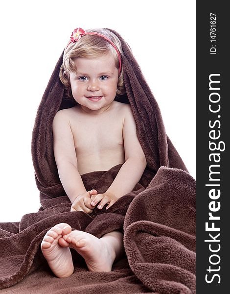 Beautiful baby under a brown towel