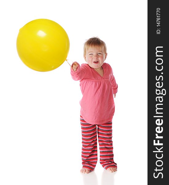 A baby girl delightedly playing with a big, yellow punch ball.  Isolated on white. A baby girl delightedly playing with a big, yellow punch ball.  Isolated on white.