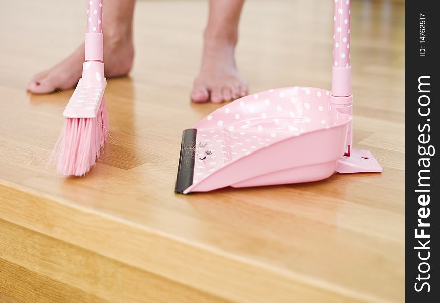 Cleaning the floor with a dust-brush