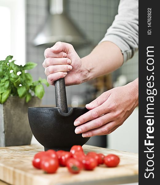 Human with a mortar in the kitchen