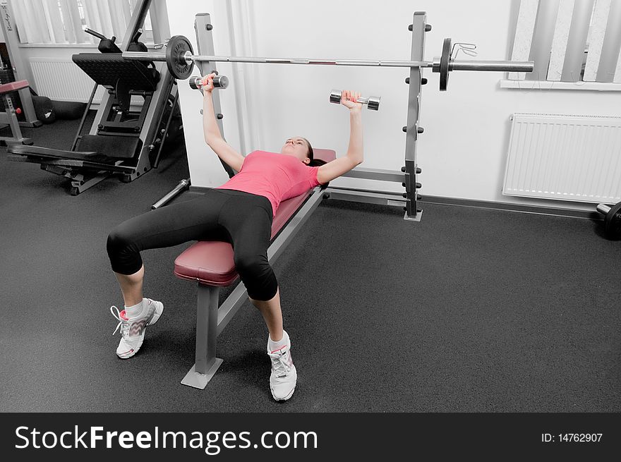 Young earopean woman making physical exercises in a gym. Young earopean woman making physical exercises in a gym