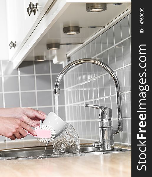 Human washing a coffee cup