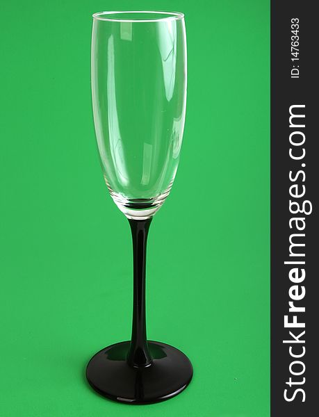 Empty wine glass isolated on green background