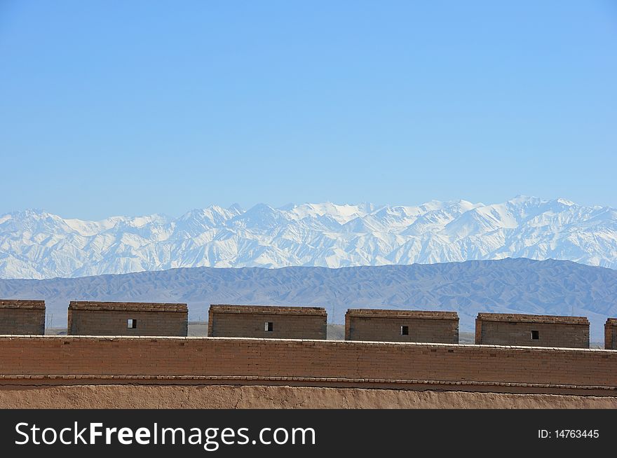 It is the famoun greatwall in jiayuguan city. this photo shows the beautiful scene of the greatwall and snow capped mountain.