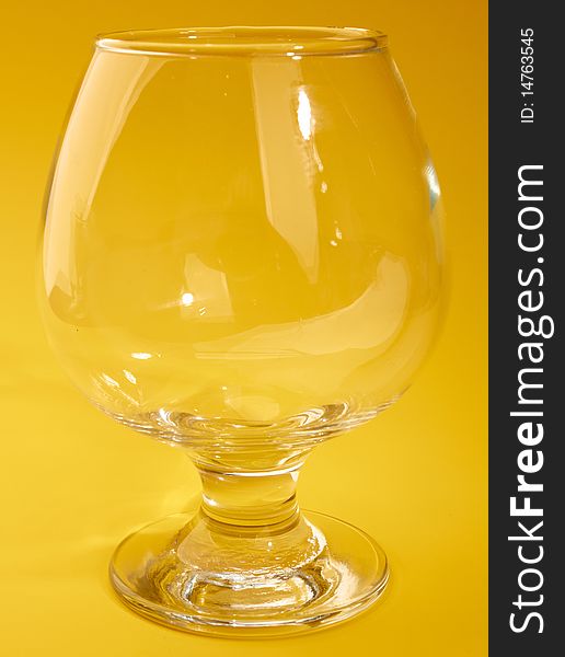 Empty wine glass isolated on yellow background