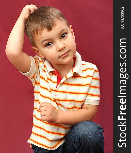 Little boy on red background