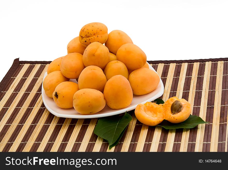 Fresh apricots on white plate