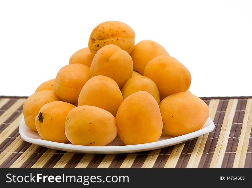 Fresh and ripe apricot on a white plate. Fresh and ripe apricot on a white plate