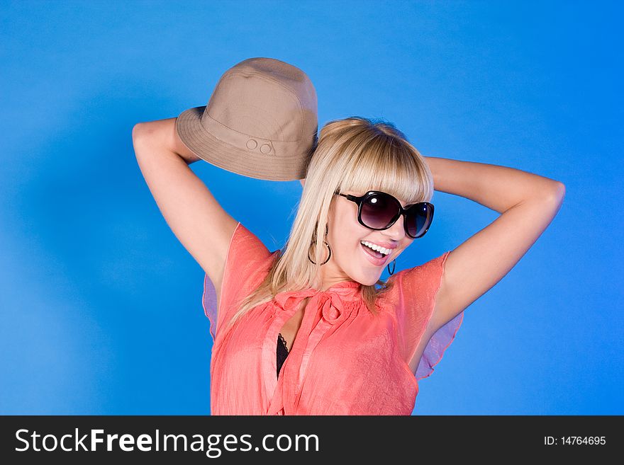 Blond fashion woman portrait wearing sunglasses and hat. Blond fashion woman portrait wearing sunglasses and hat