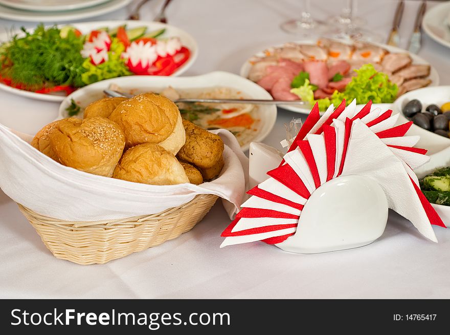 Bread and various food on a celebratory table are prepared for a party. Bread and various food on a celebratory table are prepared for a party.