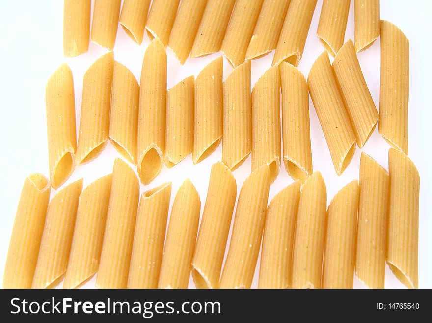 Some raw penne on white background