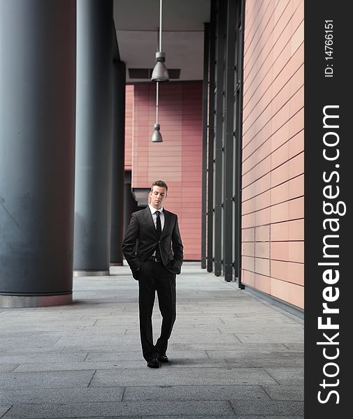 Businessman walking by an office building