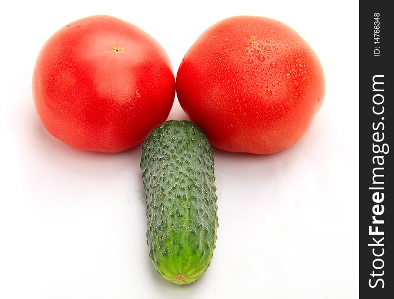 Two tomatoes and cucumber on white background, studio shot