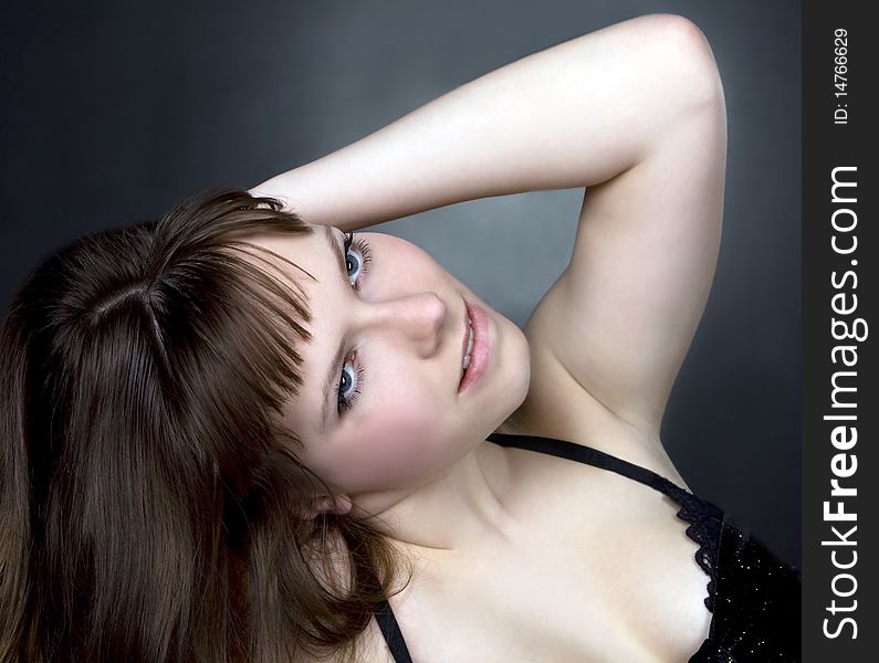 Girl posing in studio on dark background