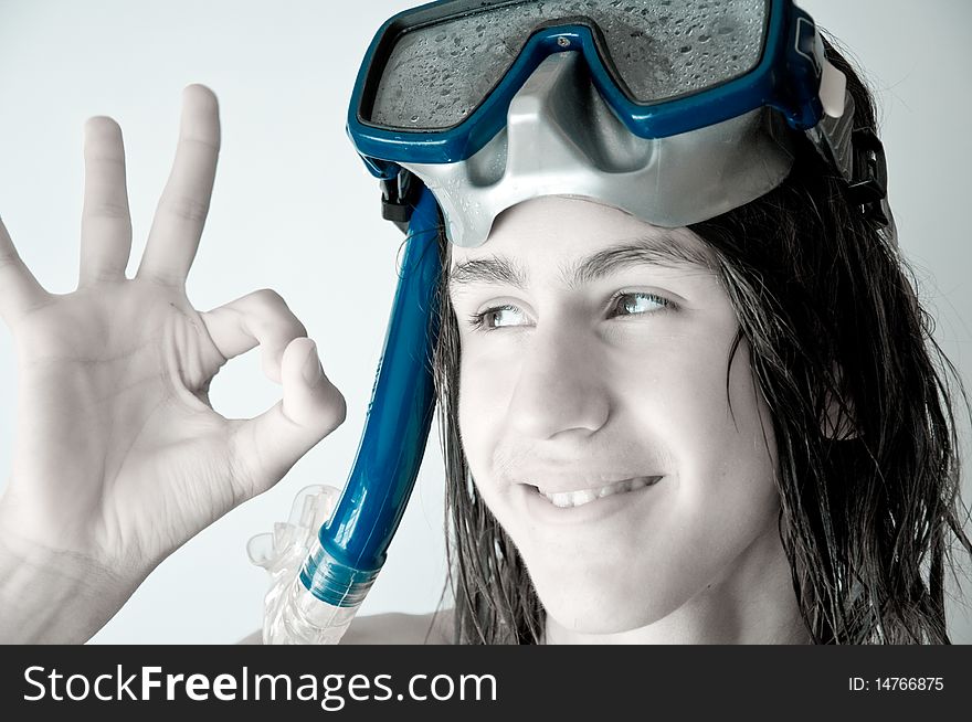 Attractive teenager with long wet hair, wearing a diving mask, showing ok. monochrome. Attractive teenager with long wet hair, wearing a diving mask, showing ok. monochrome.