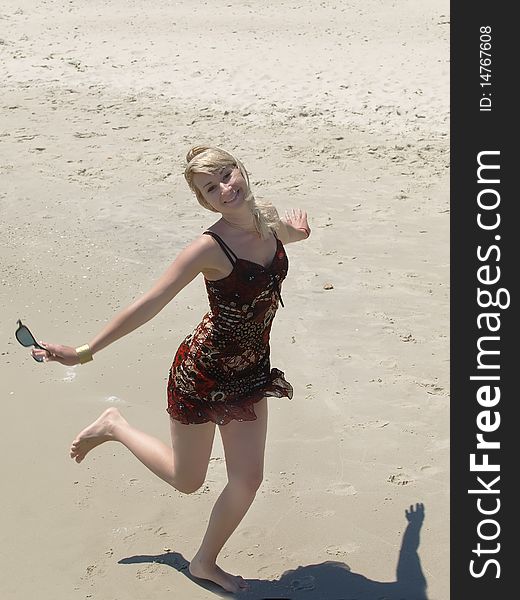 Young Blonde Woman Vacationing At The Beach