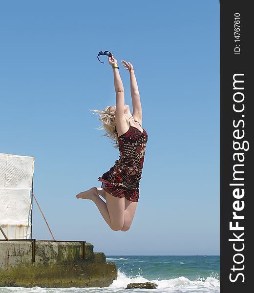 Woman Jumping On The Beach