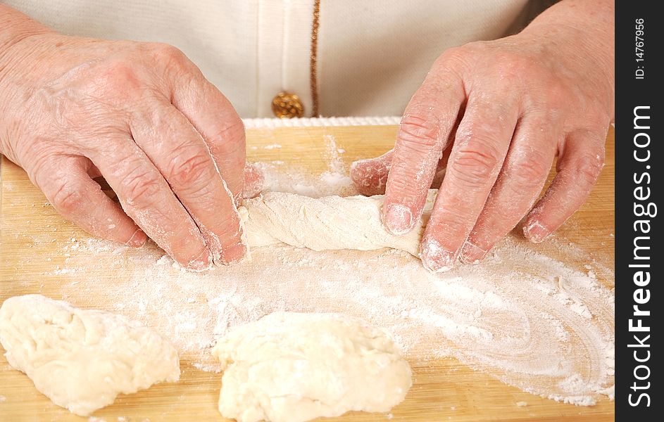 Hands of grandmother making buns