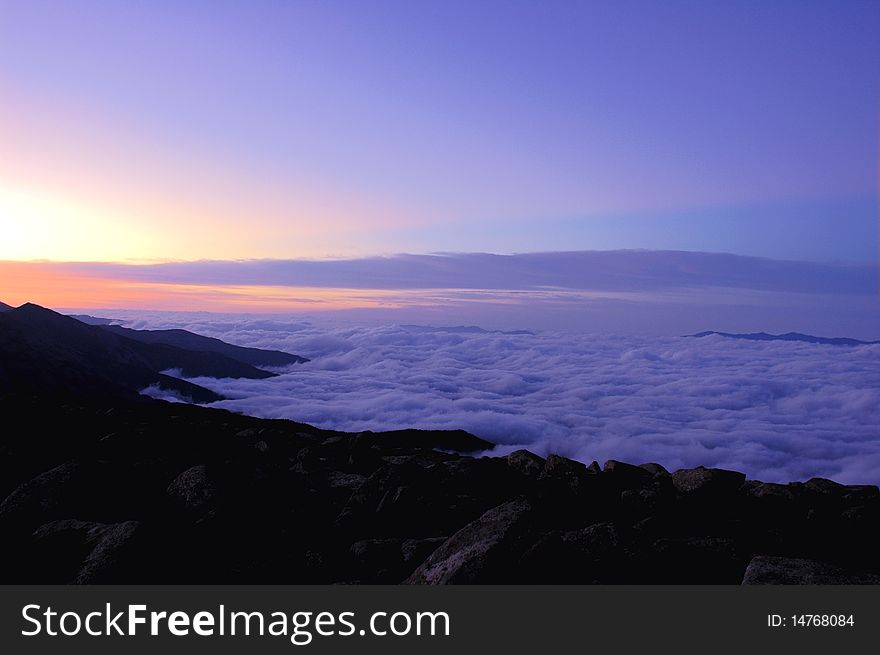 Mountains in the sea of clouds with bule sky and sunglow at daybreak