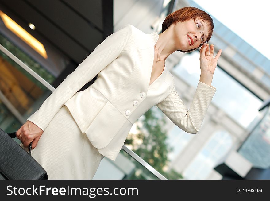 Business woman with black briefcase walking street