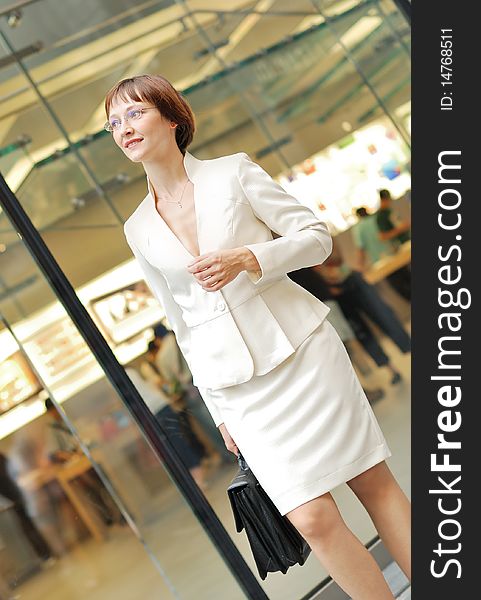 Business woman with black briefcase walking street