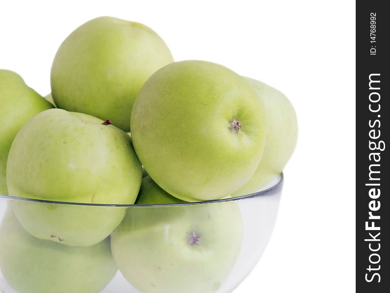 Isolated green apples in a glass bowl