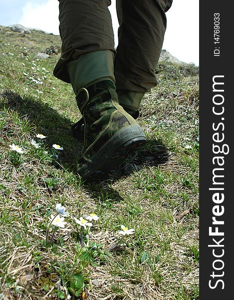 Feet of a backpacker trekking on the top of the mountains