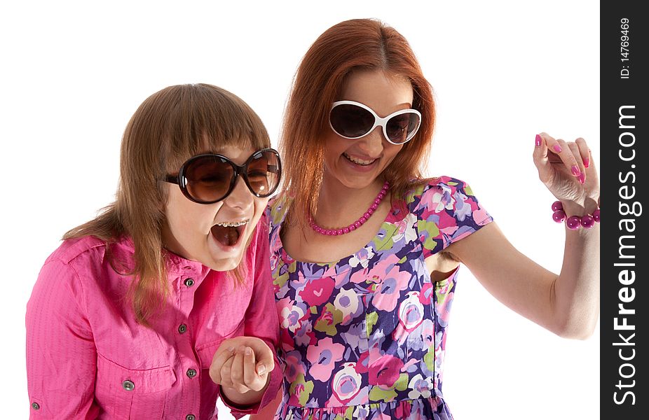 Mother and daughter smile in sunglasseses on white background