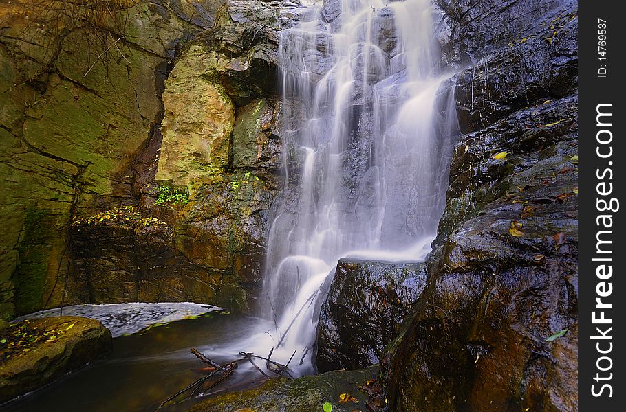 A waterfall falling calmly over rocks