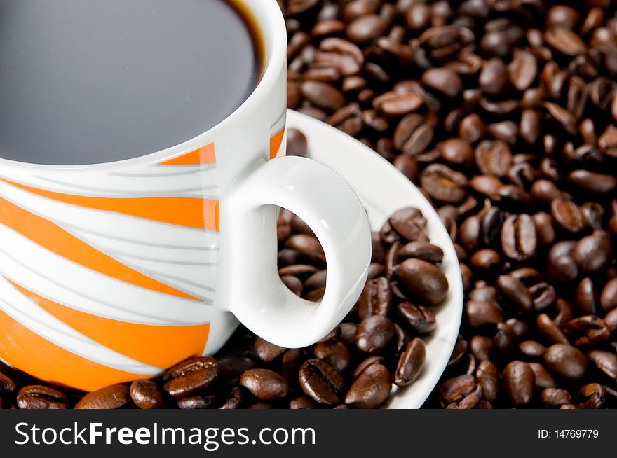 Coffee cup over coffee beans. Coffee cup over coffee beans