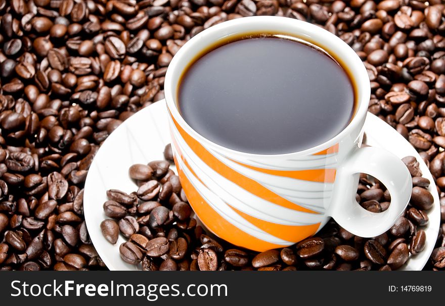 Coffee cup over coffee beans. Coffee cup over coffee beans