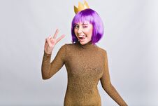 Portrait Pretty Girl With Gold Crown Having Fun In Studio. She Wears Violet Haircut, Shows Tongue And Looks Happy To Stock Images