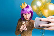 Free Charming Young Woman With Purple Haircut, Crown On Head Making Selfie Portrait On Blue Background. Golden Balloons Stock Image - 147600631