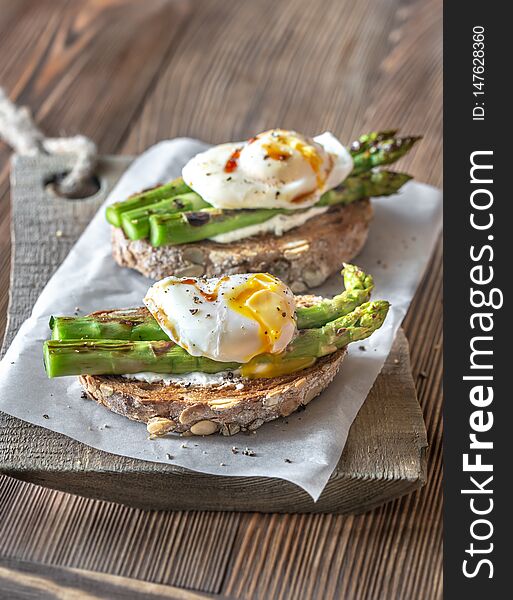 Sandwich with cream cheese, grilled asparagus and poached egg. Sandwich with cream cheese, grilled asparagus and poached egg