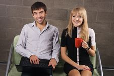 Young Man And Woman Sitting With A Laptop Royalty Free Stock Images