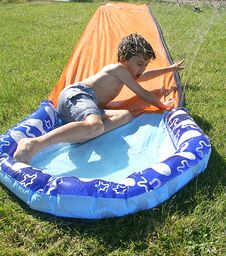 Stock Image Of Boy On Water Slide Royalty Free Stock Images