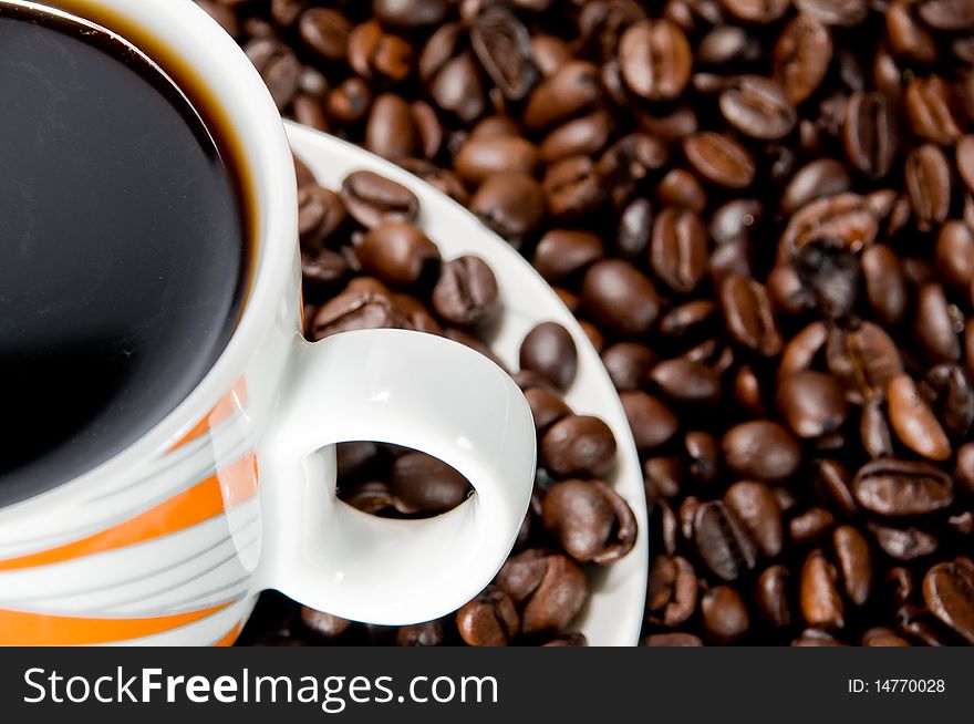 Coffee cup over coffee beans. Coffee cup over coffee beans