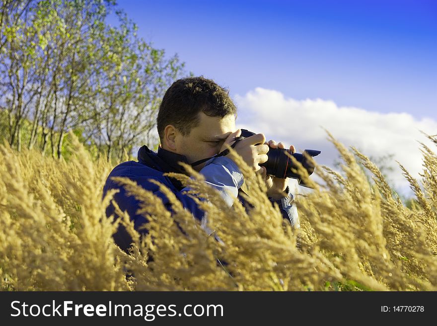 Young  Photographer On Gold Meadow