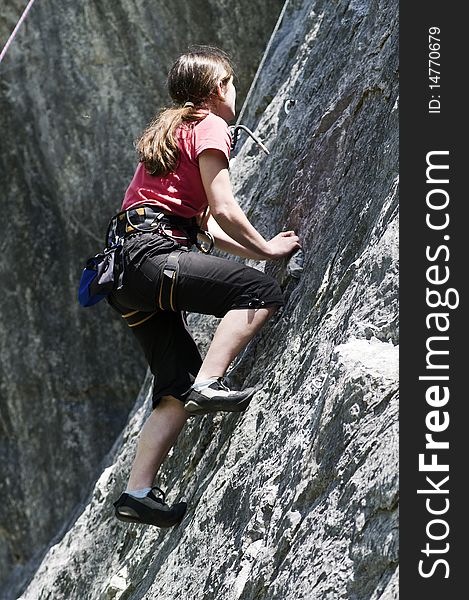 Young sportive girl in the rock face