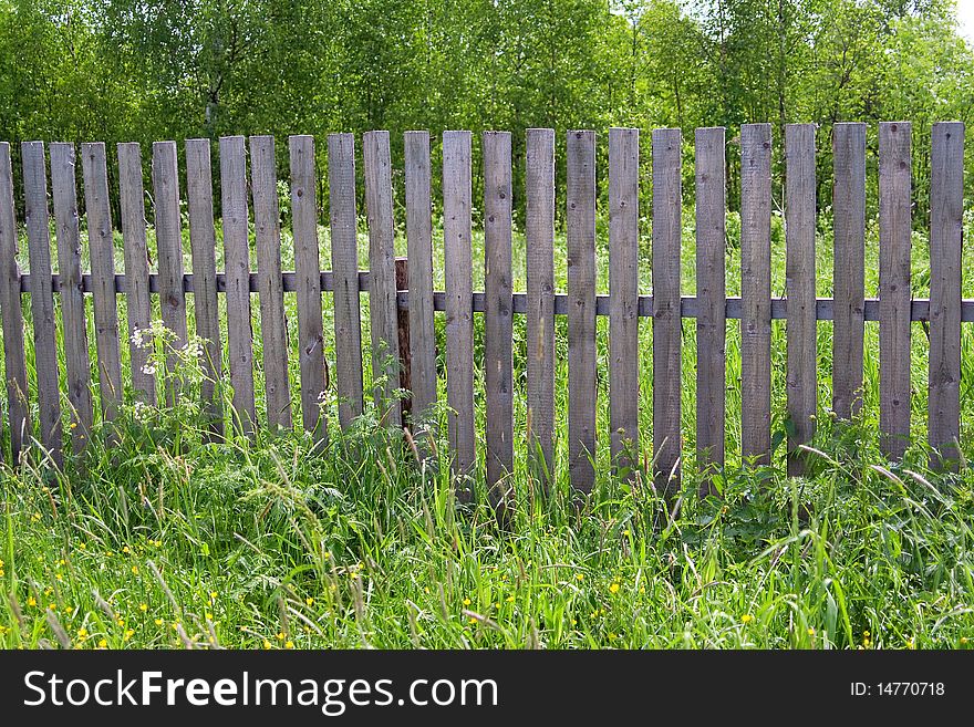 Old wooden fence in the village of fencing garden plot