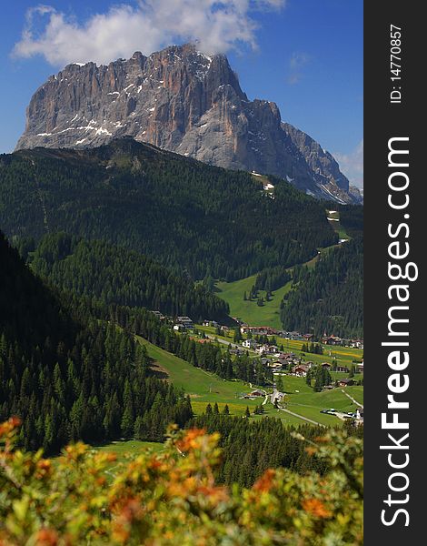 View of rocky peak with green valley in the foreground. Dolomites, Italy. View of rocky peak with green valley in the foreground. Dolomites, Italy
