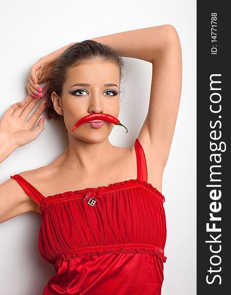 Young Girl In Red Dress With Chili Pepper