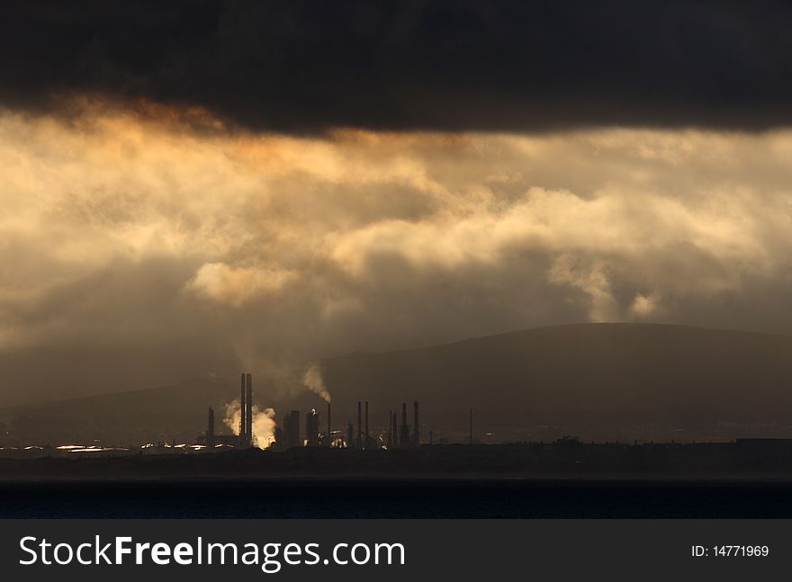 A oil refinery under clouds. A oil refinery under clouds.