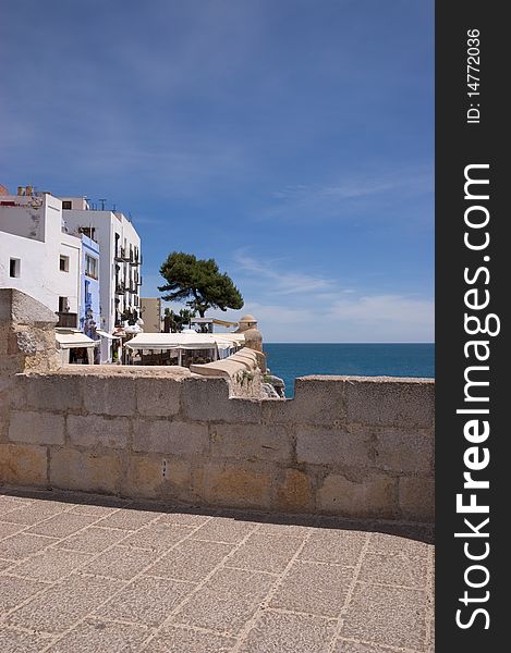 Glimpse of the fortified seaport Peniscola, located on Costa del Azahar (Spain). This popular tourist destination was built by the Knights Templars at the end of the 13th century. It is located on a rocky headland, joined to the mainland by only a narrow strip of land . Glimpse of the fortified seaport Peniscola, located on Costa del Azahar (Spain). This popular tourist destination was built by the Knights Templars at the end of the 13th century. It is located on a rocky headland, joined to the mainland by only a narrow strip of land .