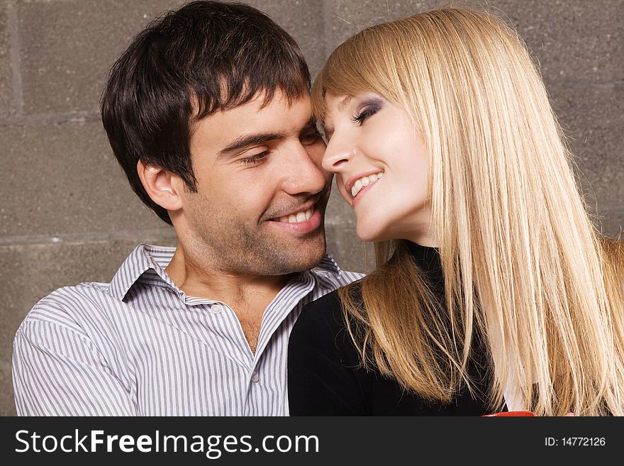 Young romantic couple kissing in house interior