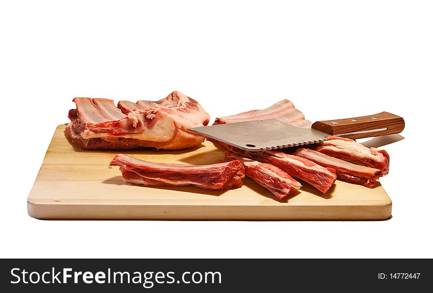 Mutton ribs and axe on chopping board. Mutton ribs and axe on chopping board