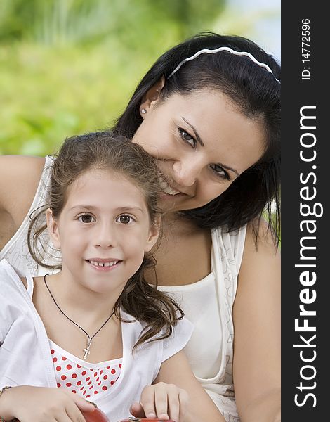 Portrait of happy mother with daughter  having good time in summer environment. Portrait of happy mother with daughter  having good time in summer environment